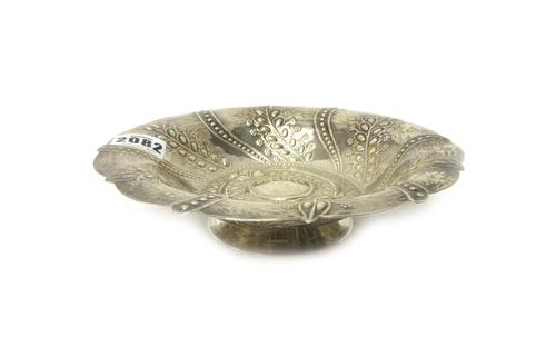 A silver pedestal bowl, of shaped circular form decorated with alternating beaded and foliate spiral bands and raised on a circular foot, 20cm diamete