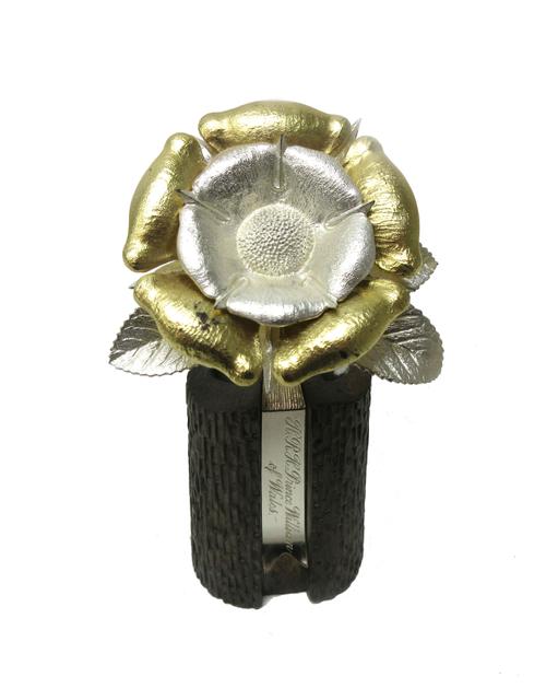 A silver and gilt model of a single rose, raised on a rustic stand, detailed H.R.H. Prince William of Wales by Christopher Lawrence, height 11cm (prod