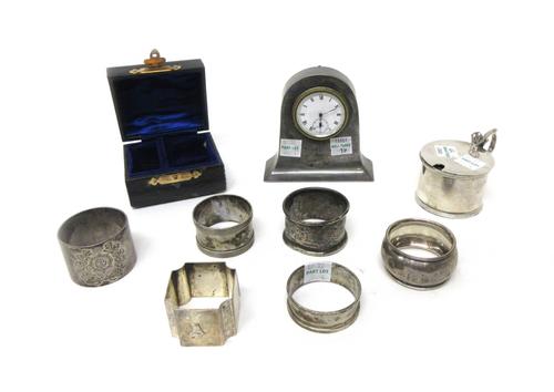 Silver and silver mounted wares, comprising; a small clock, the enamelled dial with black Roman numerals, subsidiary seconds and with blued steel hand