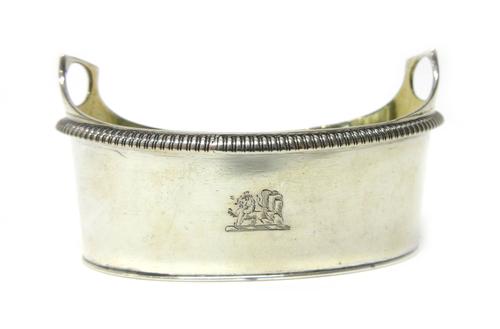 A George III silver twin handled salt, modelled as a butter tub, of oval form, having a decorated rim and gilt within, London 1802, length 8.5cm, weig