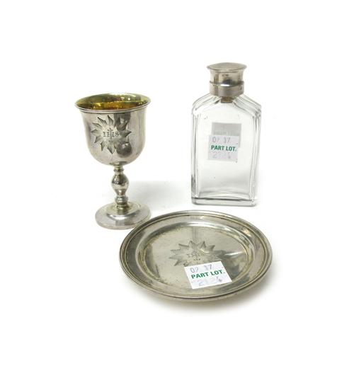A Victorian silver composite three piece travelling Holy Communion set, comprising; a chalice, London 1846, a paten, London 1848 and a glass wine bott