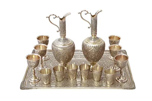 Eastern wares, comprising; a shaped rectangular tray, 36.5cm x 26.5cm, a pair of ewers, a set of six goblets and a set of six tots, mostly having simi