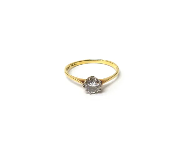 A gold and platinum, diamond set single stone ring, claw set with a circular cut diamond, detailed 18 CT PLAT, ring size P.