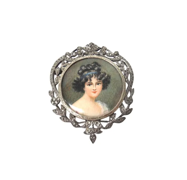 A silver and marcasite set brooch, glazed to the centre with a portrait miniature of a lady, within a scroll and foliate wreath shaped surround, possi
