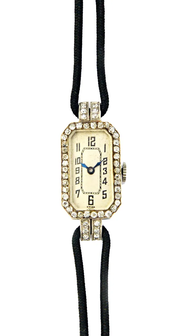 A lady's 18ct white gold and diamond set rectangular cased dress wristwatch, with an unsigned oval jewelled movement, detailed Swiss Made, the silvere