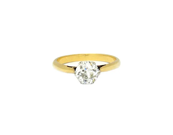 A gold and diamond single stone ring, claw set with a cushion shaped diamond, the shank unmarked, ring size M and a half, the diamond weighs approxima