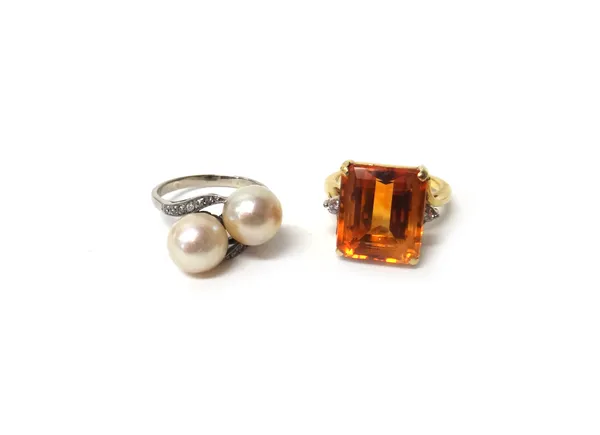 A gold ring, claw set with a cut cornered rectangular step cut citrine at the centre, between two circular cut diamonds, in a twist design, ring size