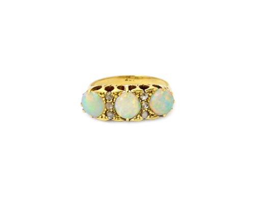 A gold, opal and diamond ring, mounted with three opals and with two rows of three rose cut diamonds mounted at intervals, ring size P and a half, wit
