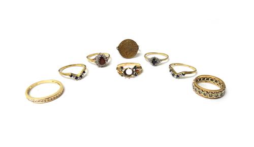 A set of three 9ct gold, sapphire and diamond set rings, a 14ct gold and colourless gem set half hoop ring, a 9ct gold, red and colourless gem set clu