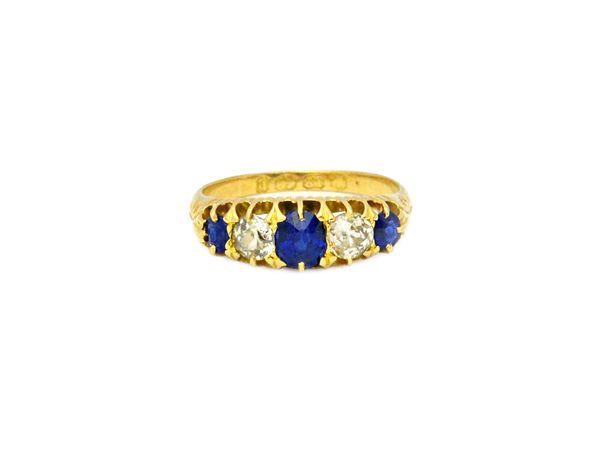 A Victorian 18ct gold, sapphire and diamond set five stone ring, mounted with three cushion shaped sapphires, alternating with two cushion shaped diam