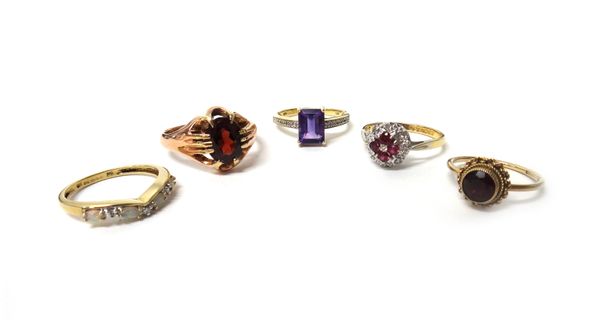 An 18ct gold, ruby and diamond set cluster ring, a gold ring claw set with an oval cut garnet, detailed 9CT, a 9ct gold ring mounted with a rectangula