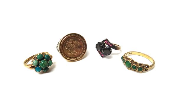 A 9ct gold ring mounted with an imitation Mexican coin, a black cabochon sapphire and pale ruby set ring, in a crossover design, a 9ct gold and turquo