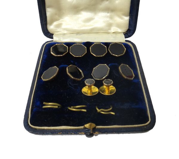 A gold mounted black onyx set evening wear dress set, comprising; a pair of cufflinks, a pair of studs and four dress buttons, each of octagonal form,