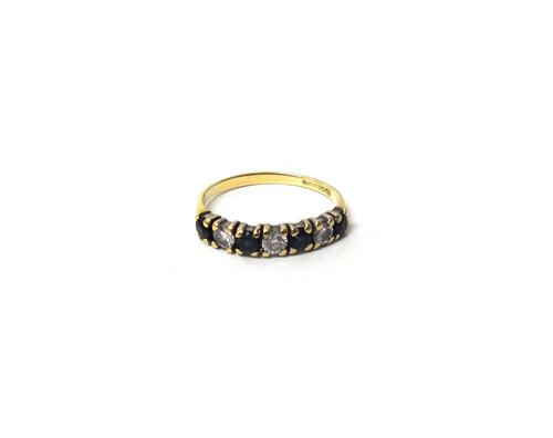 An 18ct gold, sapphire and diamond seven stone half hoop ring, mounted with four circular cut sapphires alternating with three circular cut diamonds,