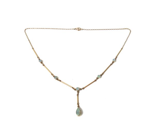 A 9ct gold and opal pendant necklace, the drop collet set with a pear shaped opal, otherwise mounted with five smaller circular opals above, connected