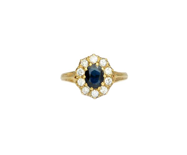 A 9ct gold, sapphire and diamond set oval cluster ring, claw set with the oval cut sapphire at the centre, in a surround of ten circular cut diamonds,