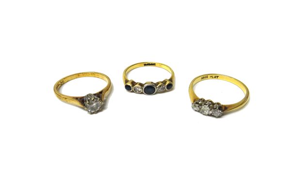 A gold and platinum, sapphire and diamond set five stone ring, a gold and platinum, diamond set three stone ring, claw set with cushion shaped diamond