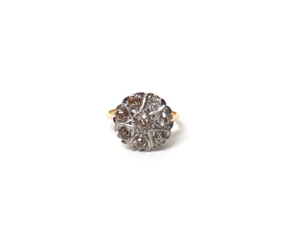 A gold and diamond set seven stone cluster ring, mounted with cushion shaped diamonds, ring size O and a half, with a case.