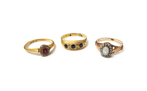 An 18ct gold, ruby and diamond set nine stone oval cluster ring, Chester 1912, a gold, opal and seed pearl set oval cluster ring, detailed 585 and a g