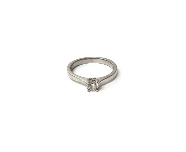 A platinum and diamond set single stone ring, claw set with a circular cut diamond, ring size K.