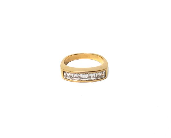 A gold and diamond set five stone ring, mounted with a row of square emerald cut diamonds, in an undecorated setting, indistinctly marked 750, ring si