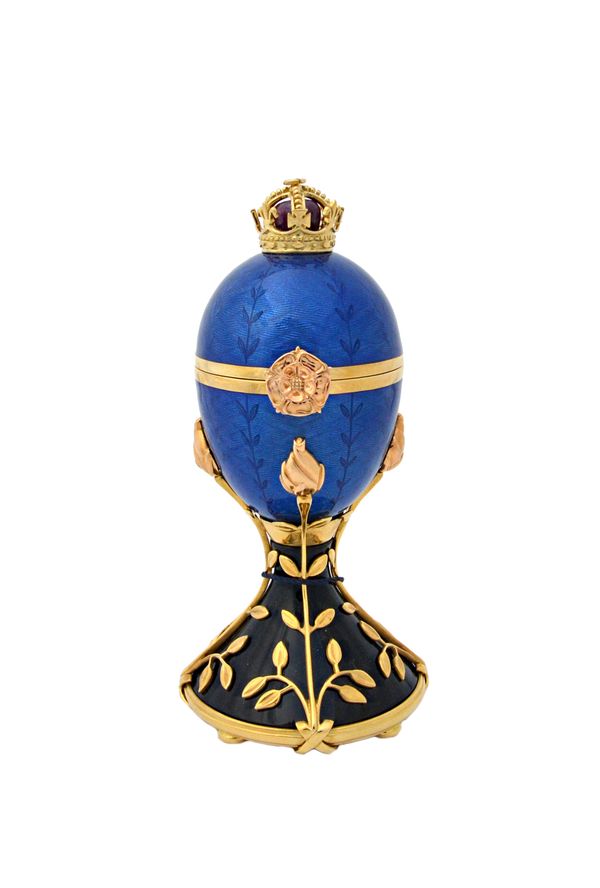 An 18ct gold mounted and enamelled hinged ornamental egg by Victor Mayer for Faberge, the blue enamelled egg opening to reveal a detachable 18ct gold