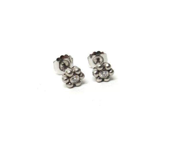 A pair of white gold and diamond set single stone earstuds, each collet set with a circular cut diamond, within a beaded surround, detailed 585, the b