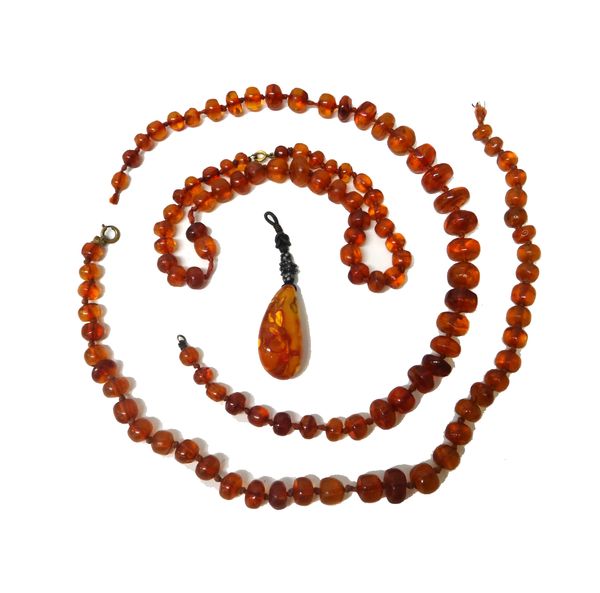 Three rows of irregular reconstituted translucent amber beads and a reconstituted semi-translucent drop shaped amber pendant, (4).