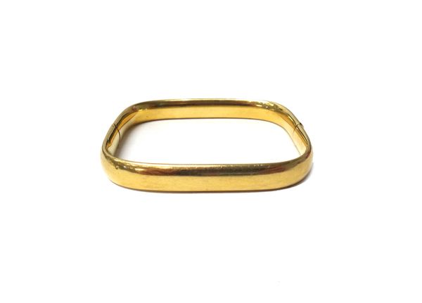 A gold hollow hinged bangle, of curved square form, on a snap clasp, detailed 750, gross weight 21 gms.