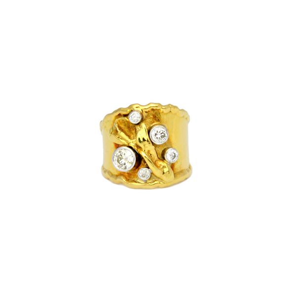 An 18ct gold and diamond set ring, in a wide band abstract design, collet set with five circular cut diamonds, between raised cast sides, ring size S,