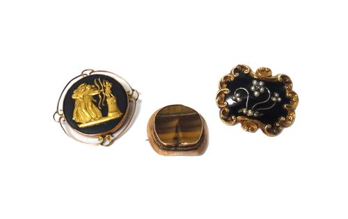 A Victorian black enamelled and half pearl set shaped rectangular mourning brooch, the front applied with a forget-me-not spray, centred by a rose dia