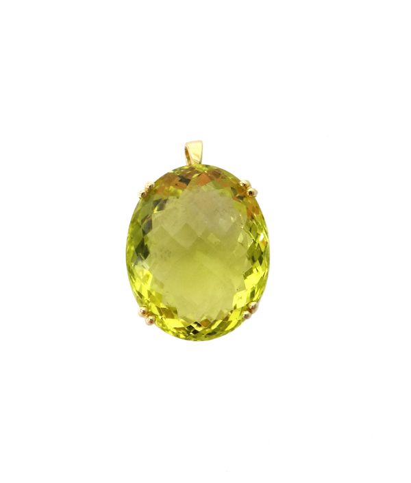 An 18ct gold mounted, yellow gem set oval pendant, claw set with a large oval cut yellow gem.  Illustrated