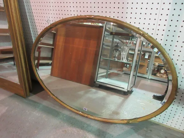 A 20th century oval gilt mirror, 111cm wide x 76cm high. A3