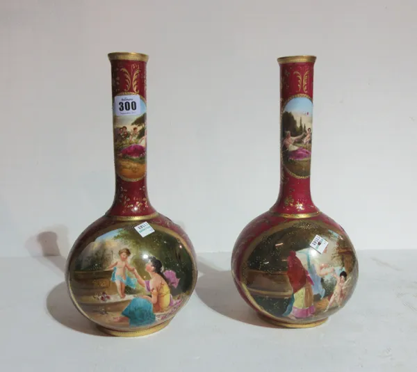 A pair of Continental ceramic bottle vases, decorated with pink floral and cherub scenes, (a.f). S11T