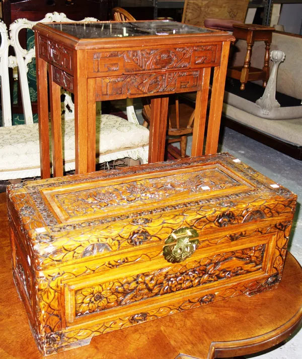 A nest of two 20th century Chinese hardwood tables, together with a 20th century carved trunk, (3). D5