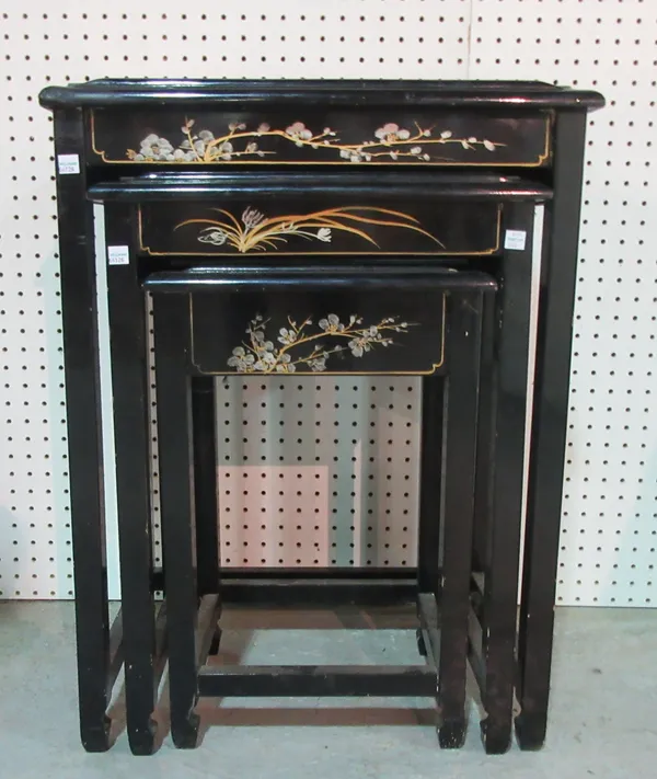 A nest of three 20th century ebonised Chinese tables, decorated with mother of pearl figurines, 51cm wide x 66cm high, (3). D5