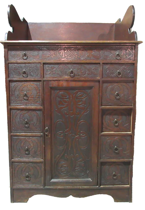 An 18th century and later oak clerk's desk, with twelve drawers about the cupboard. I4