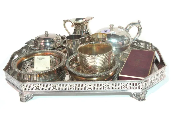A group of silver plated wares, comprising; a rectangular cut cornered gallery tray, a circular salver with a pierced border, three bottle coasters, a