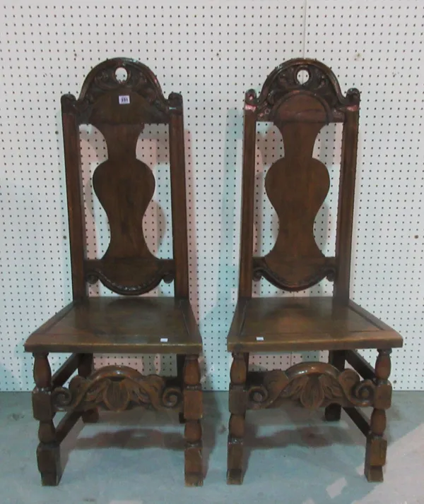 A pair of late 17th century style carved oak arch back side chairs, 120cm high, (2).    E2
