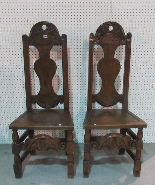 A pair of late 17th century style carved oak arch back side chairs, 120cm high, (2).    E2