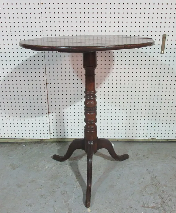 An 18th century oak circular tripod table, on turned supports, 61cm wide x 74cm high.  H8