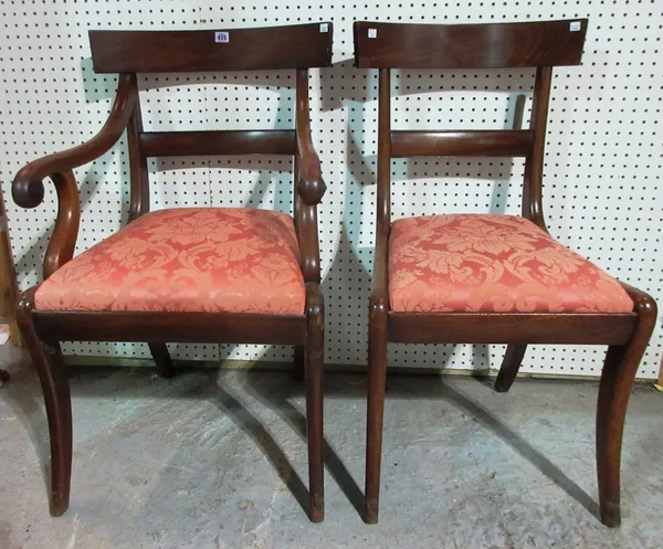 A set of five late Regency mahogany bar back dining chairs on sabre supports and another similar, (6).  F7