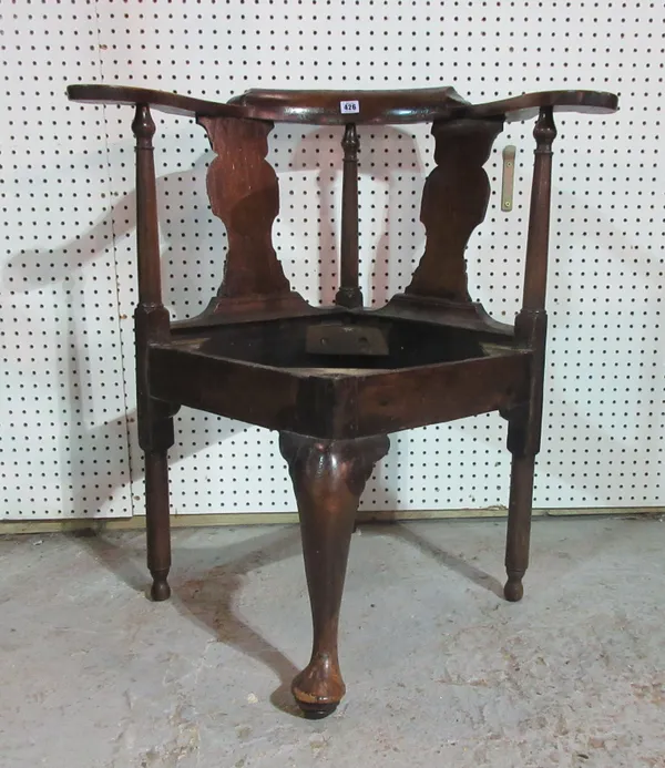An early 18th century mahogany corner chair, with vase back and outswept arms.  I4