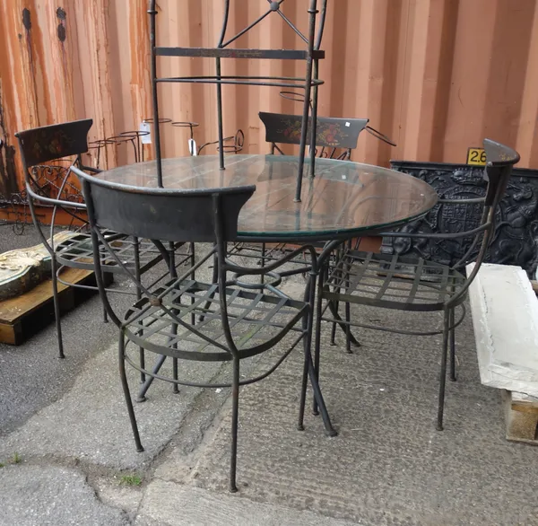 A metal garden table with circular glass top together with five chairs painted with floral decoration, (6).  OUTSIDE