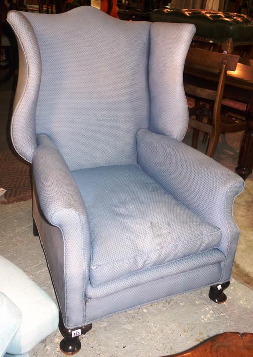 A George III mahogany framed wing back armchair.  F8