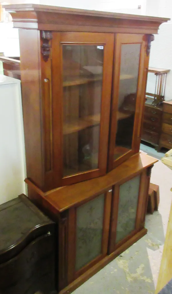 A Victorian double height mahogany glazed bookcase with scroll mounts, 147cm wide x 245cm high. L10