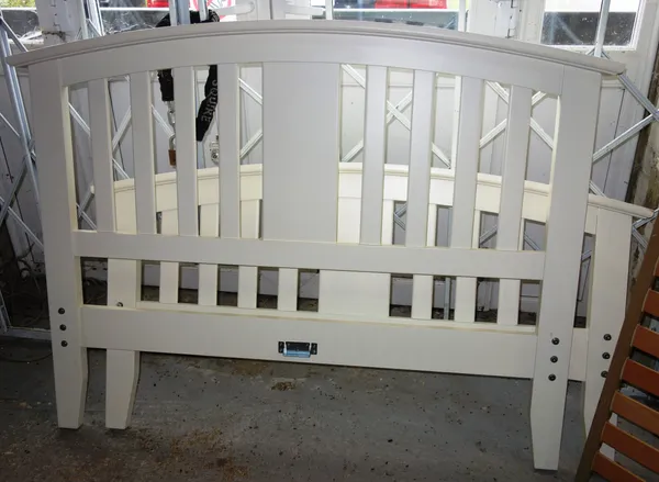 A 20th century white painted double bed, with arch top slatted head and footboard, 153cm wide.  A9