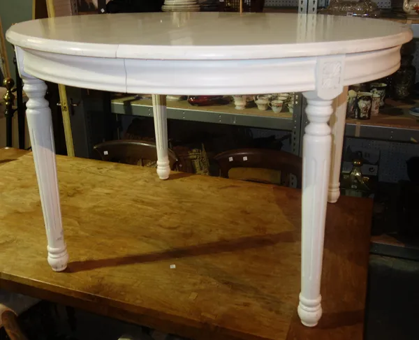 A 20th century white painted circular extending dining table, 168cm wide fully extended.  L2