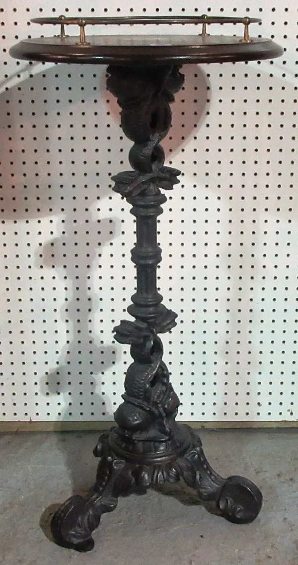 A cast iron table base framed as intertwined dolphins.  G6
