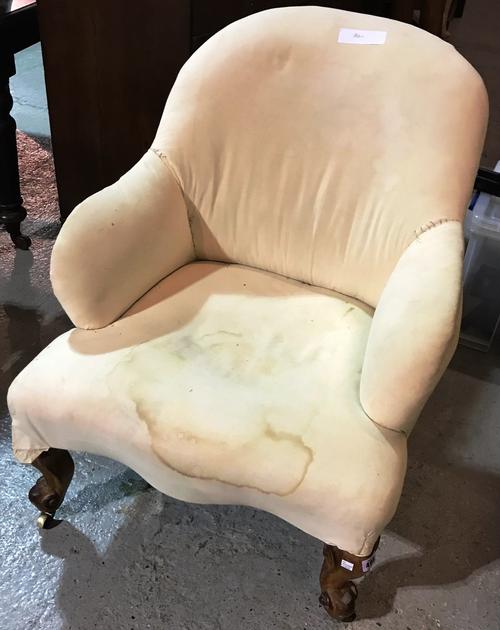 A Victorian tub back easy armchair, on walnut scroll supports, 82cm high.   J5